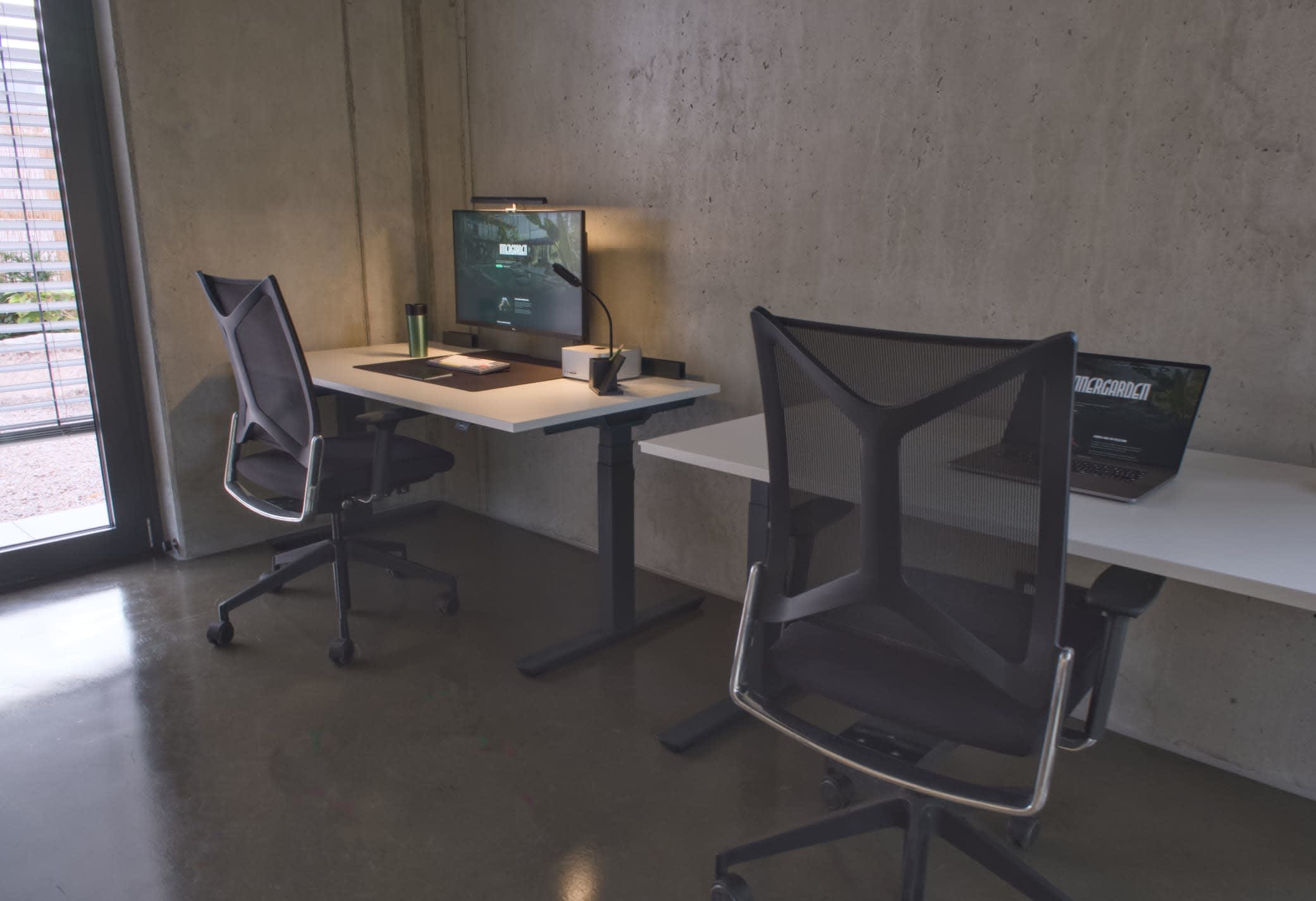 Workstations surrounded by plants inside Innergarden